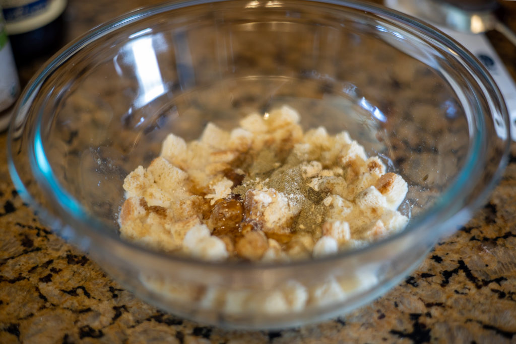 a bowl with stuffing mix, buttermilk, and spices for meatloaf