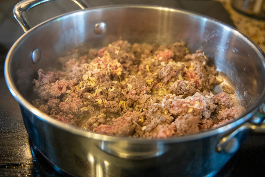 ground beef partially cooked with minced onion added