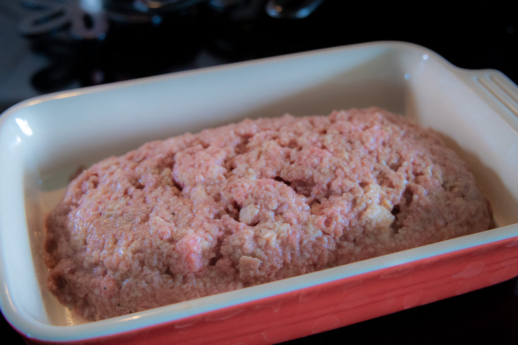 a meatloaf mixture in a baking dish, waiting to go into the oven